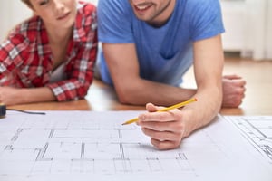 Couple syudying home plans